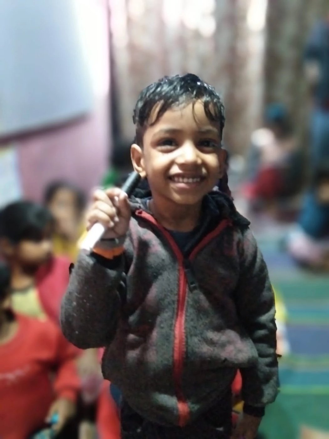 A smiling child at an Aadi Foundation centre